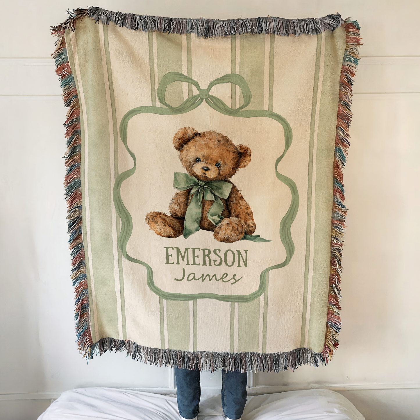 Personalized teddy bear baby blanket with custom name and vintage nursery design draped over crib